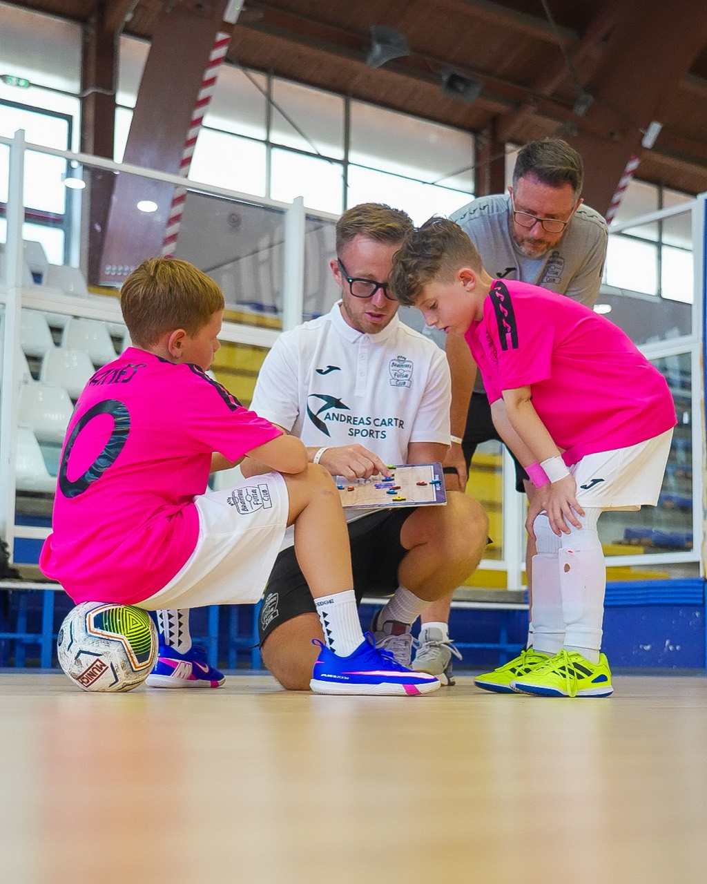 Jack Harrod discussing futsal tactics with young Braintree players